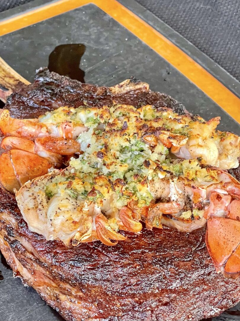 finished lobster on top of a steak