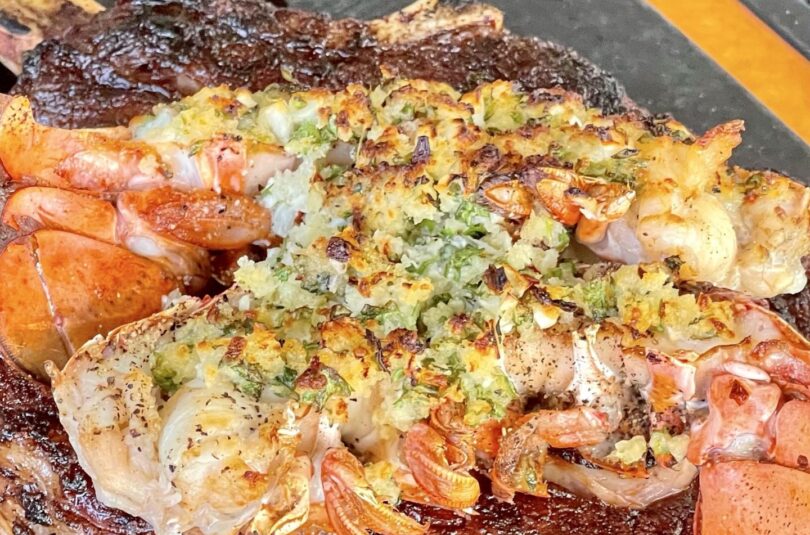 finished lobster on top of a steak