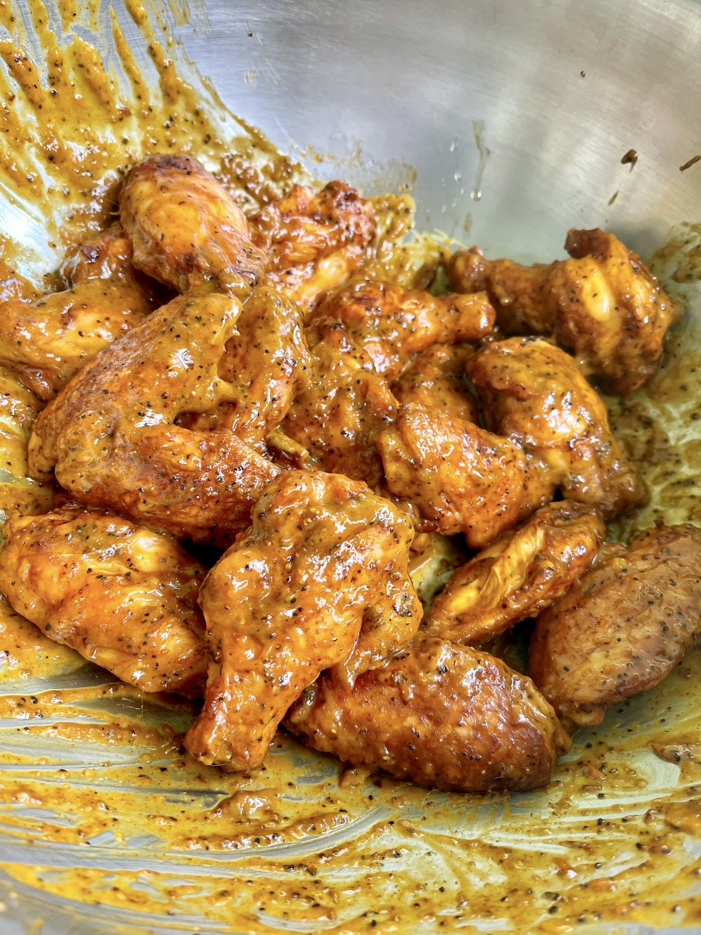 sauced chicken wings in a bowl