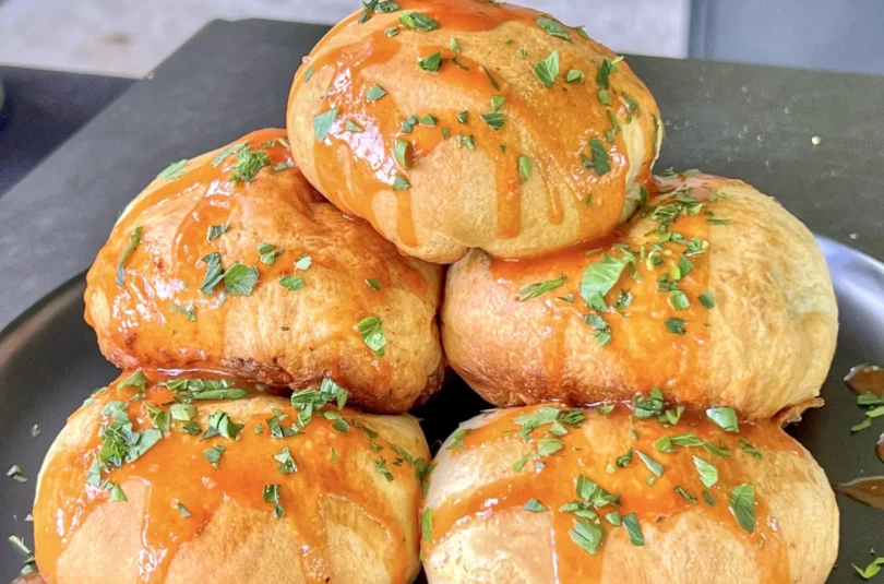 buffalo chicken bites with sauce on them