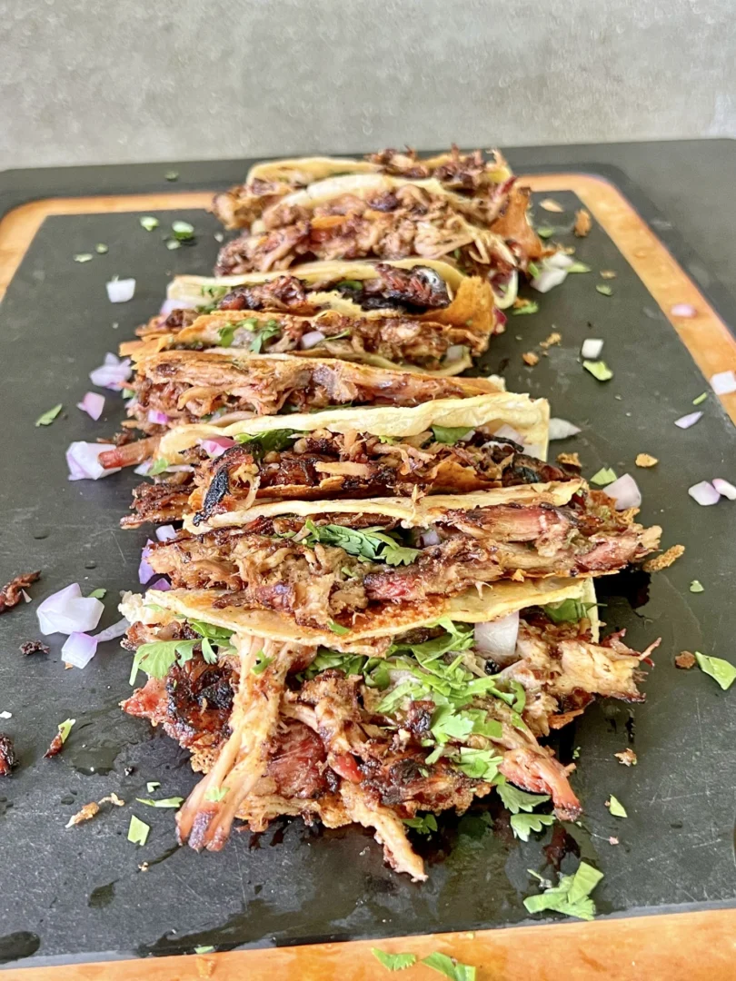 pulled pork carnitas on a cutting board