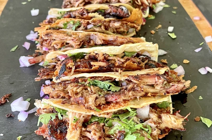 pulled pork carnitas on a cutting board