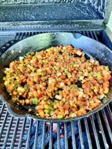 bolognese sauce cooking in a cast iron skillet