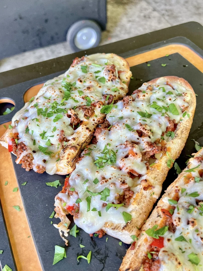 cored bread with a Bolognese sauce on the smoker