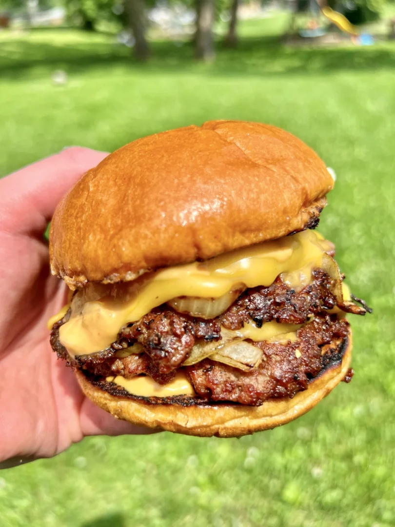 smash burgers with a grassy background
