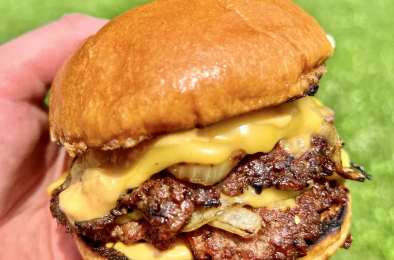 smash burgers with a grassy background