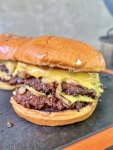 smash burgers on a cutting board