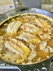 butter basting lobster in a cast iron skillet