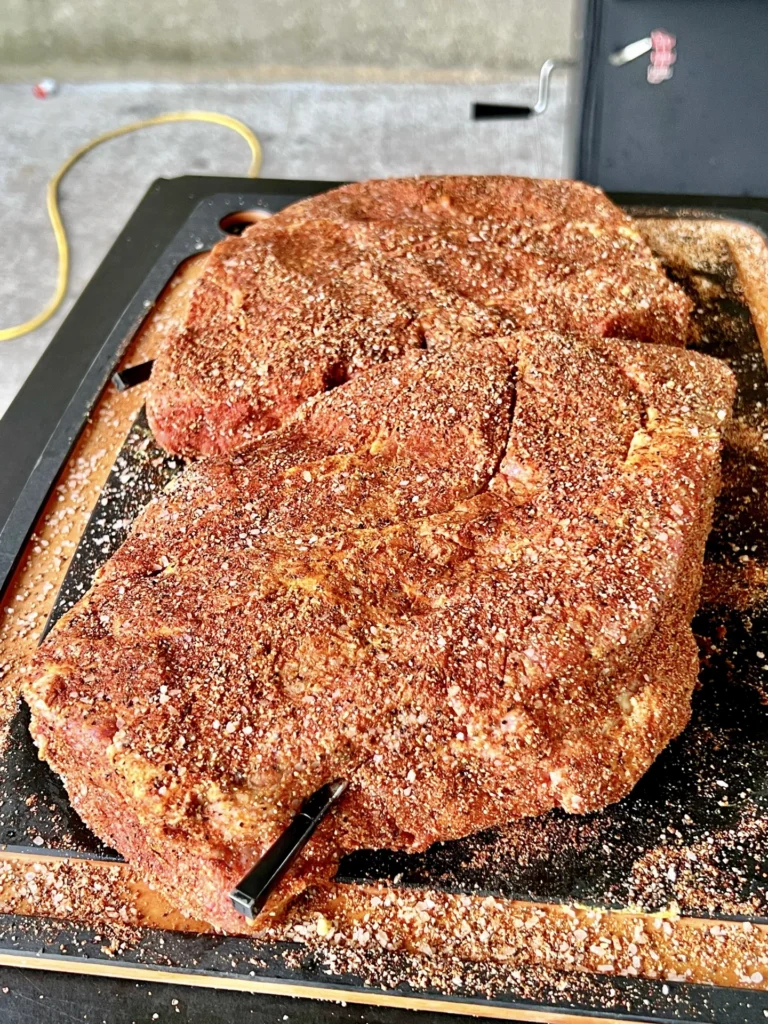 seasoned chuck roast on a cutting board