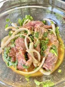 chimichurri in a bowl with meat