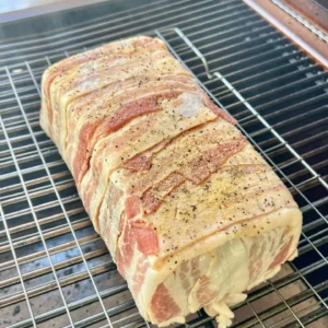 bacon wrapped meatloaf on a rack