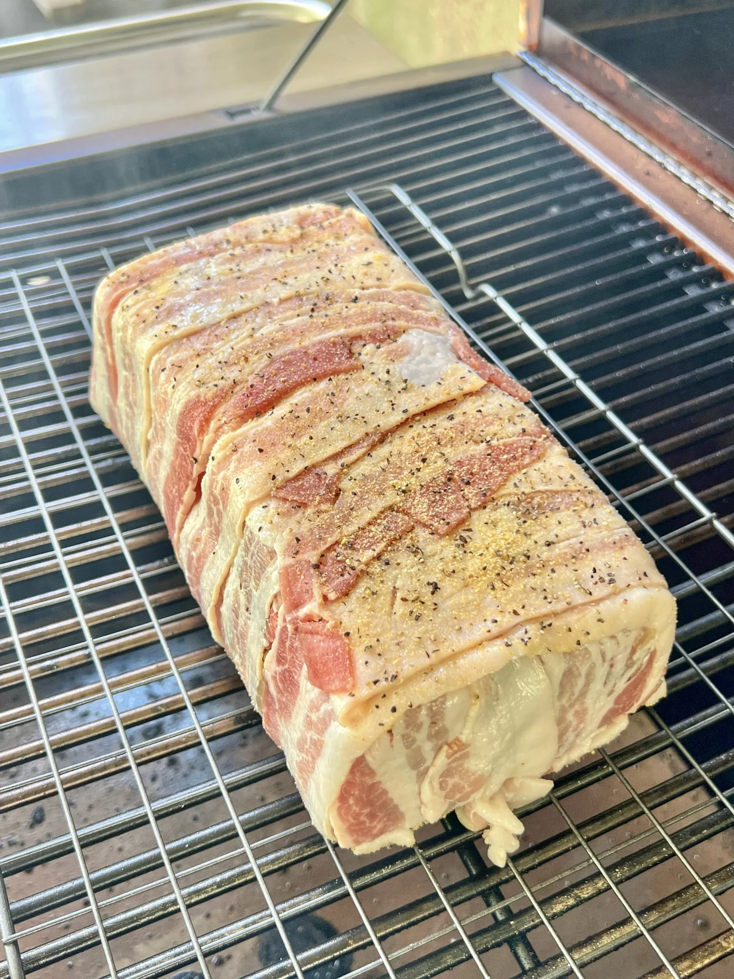 bacon wrapped meatloaf on a rack
