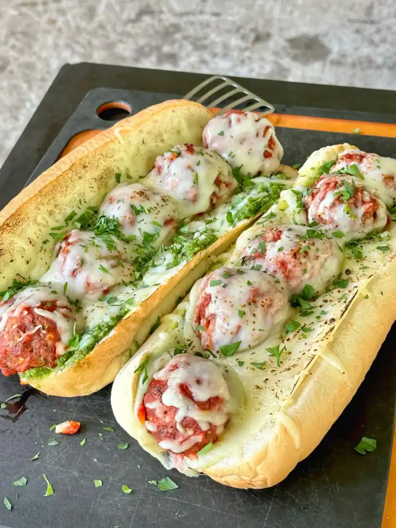 smoked meatball subs on a cutting board