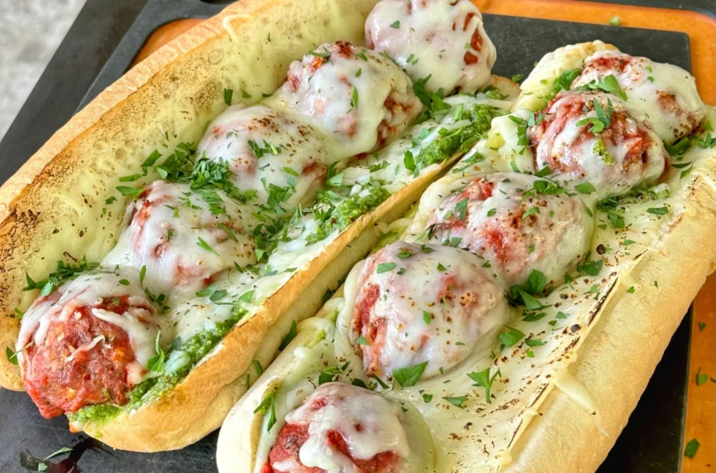 smoked meatball subs on a cutting board