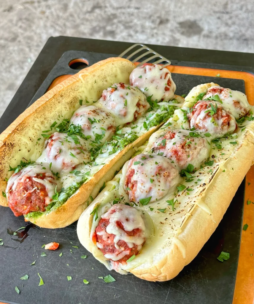 smoked meatball subs on a cutting board
