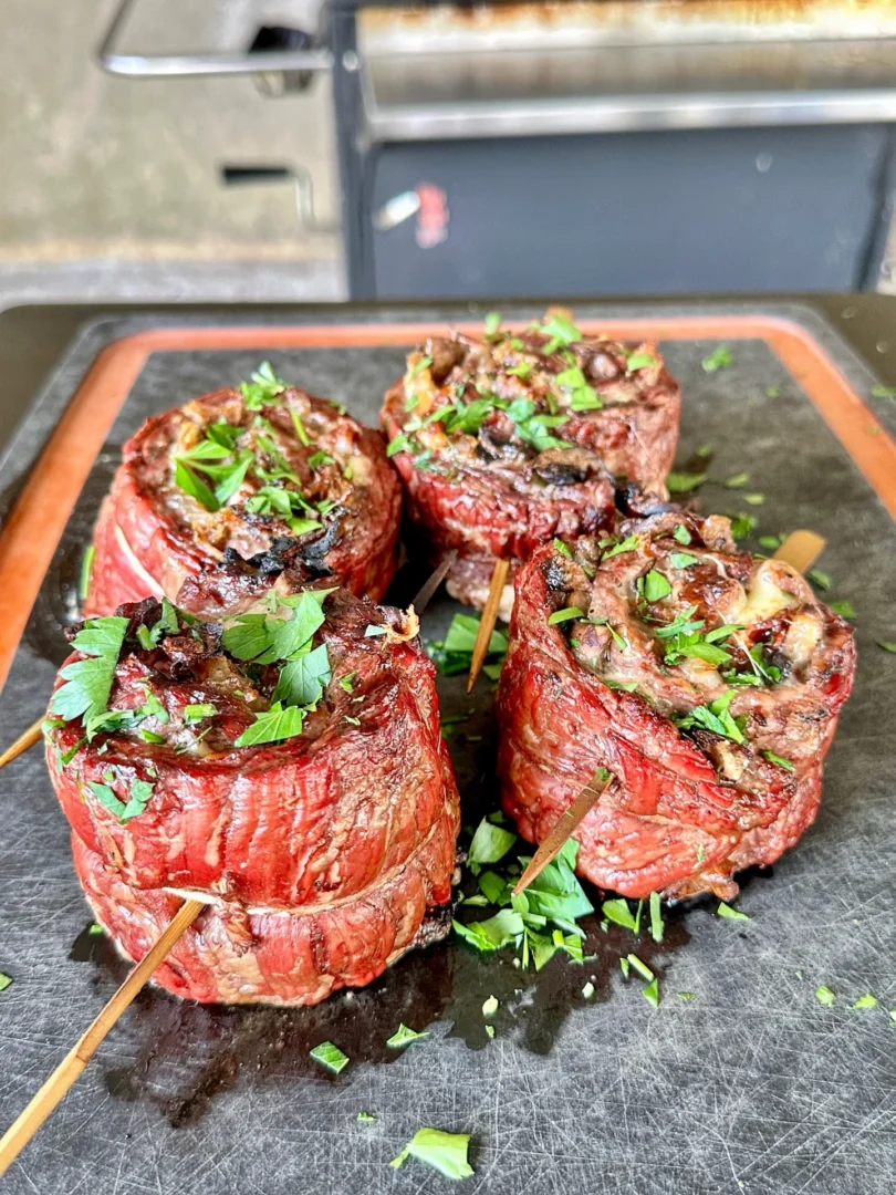 grilled steak pinwheels on a cutting board