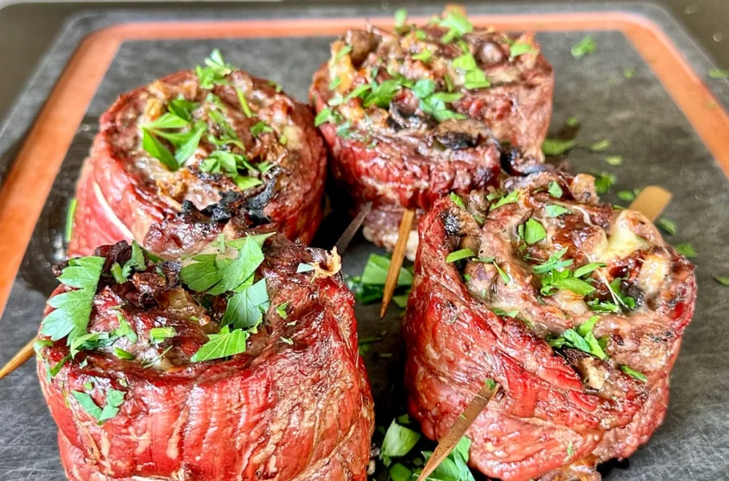 grilled steak pinwheels on a cutting board