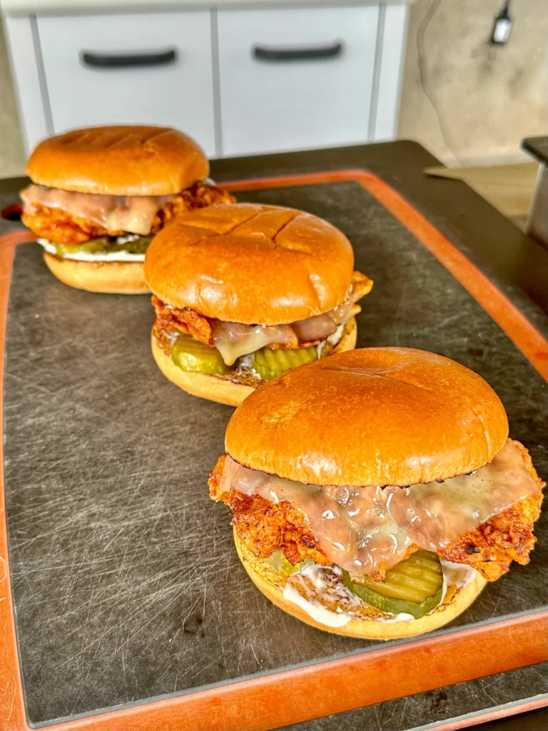 3 nashville hot chicken sandwiches on the cutting board