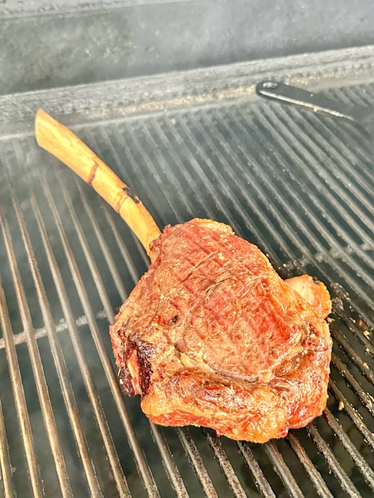 grilled tomahawk on the smoker