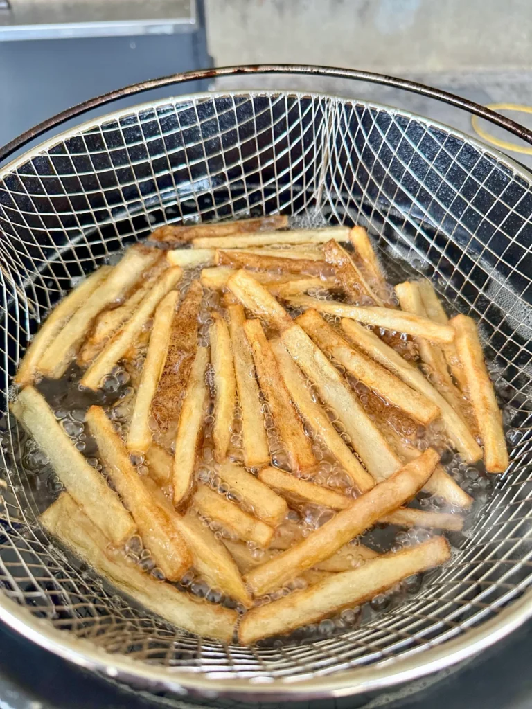 crispy homemade fries in the deep fryer