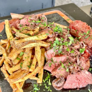 sliced up steak and fries