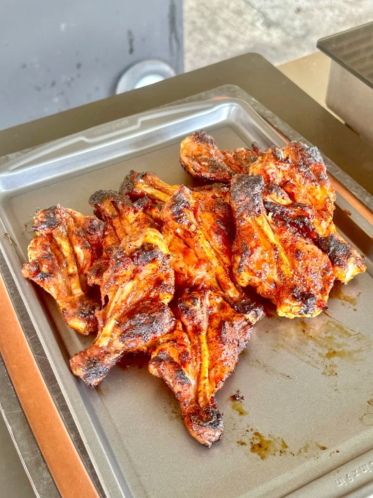 smoked chicken on a resting rack