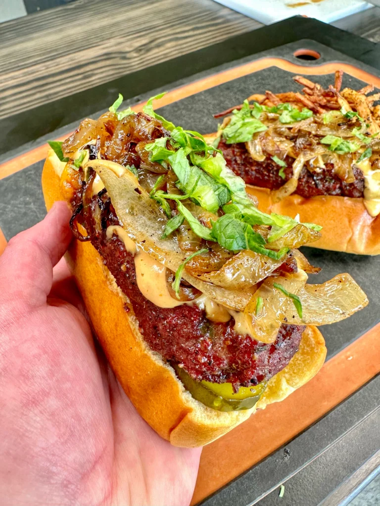 holding a beef dog over other dogs