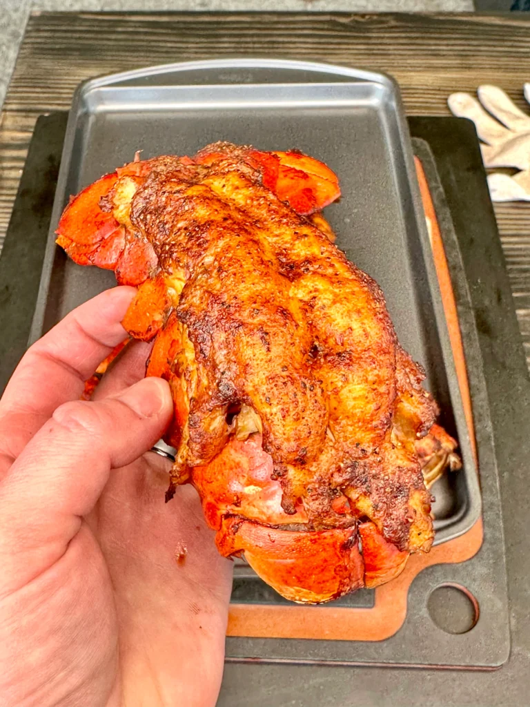smoked lobster being held