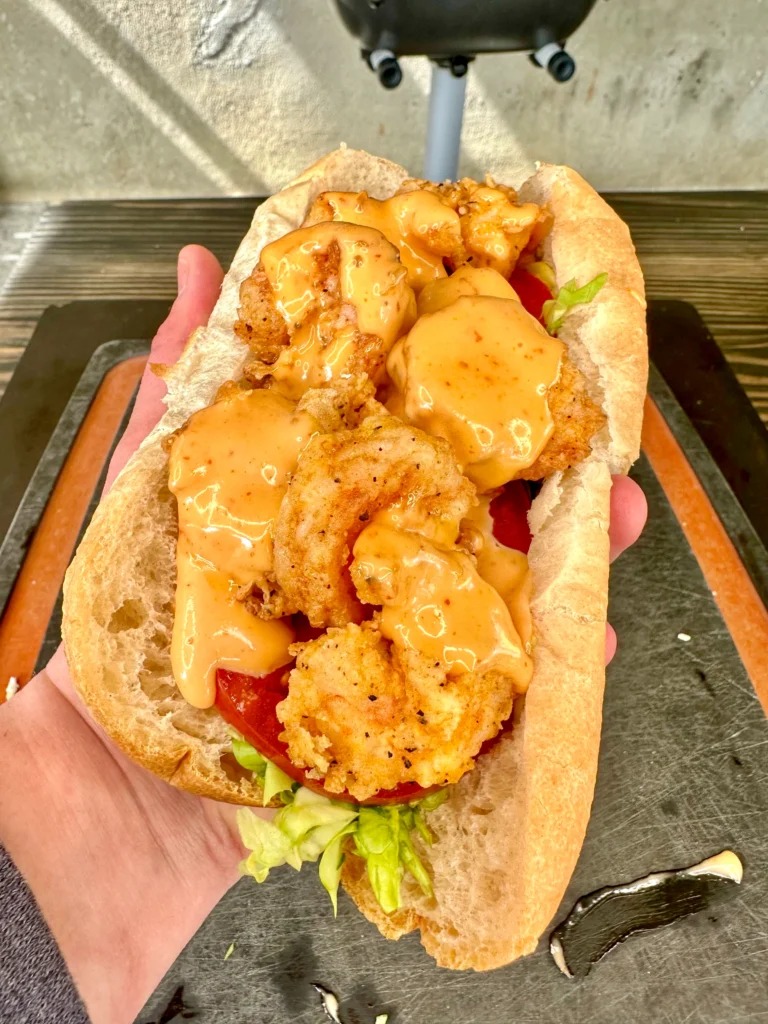 shrimp po boy being held