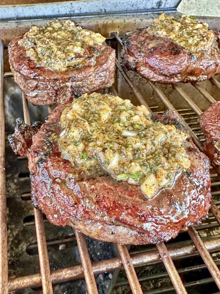roasted garlic butter on the ribeye steaks