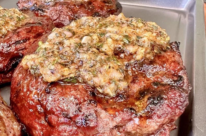 garlic butter ribeye on a resting tray