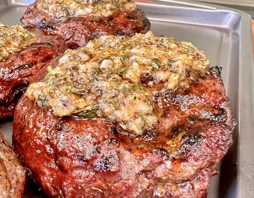 garlic butter ribeye on a resting tray