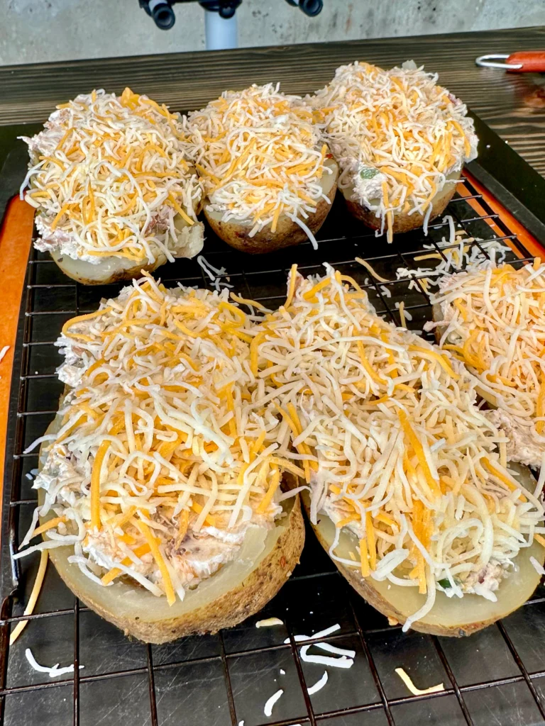 shredded cheese on top of the stuffed potato skins