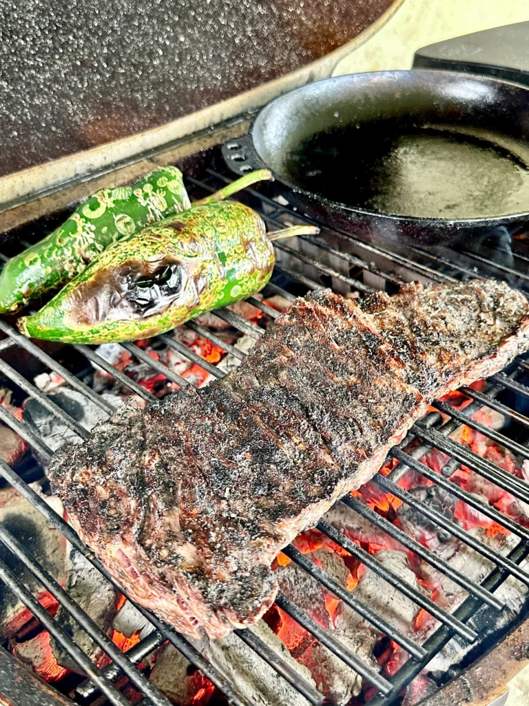skirt steak on the grill with a pepper