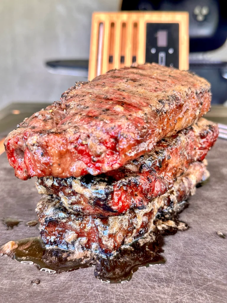 stacked steaks on a cutting board