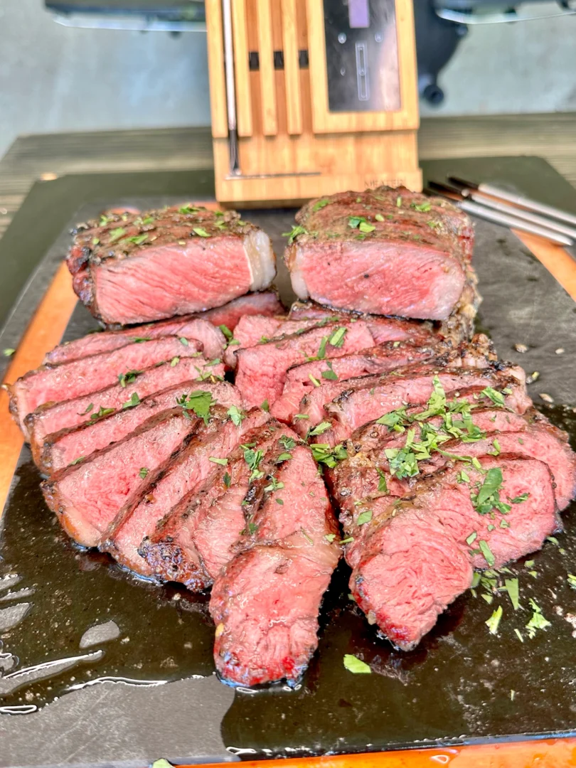 caramelized onion butter steaks on a cutting board