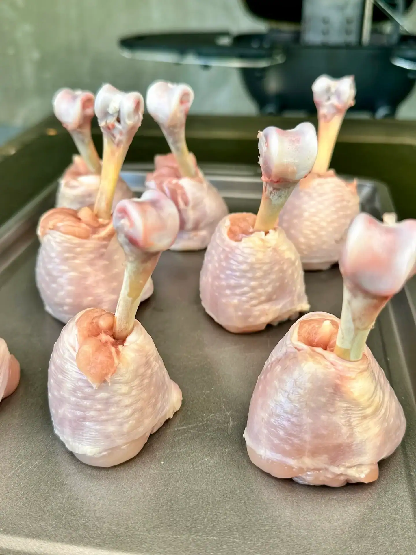 Chicken drumsticks trimmed into lollipop shapes with exposed bones