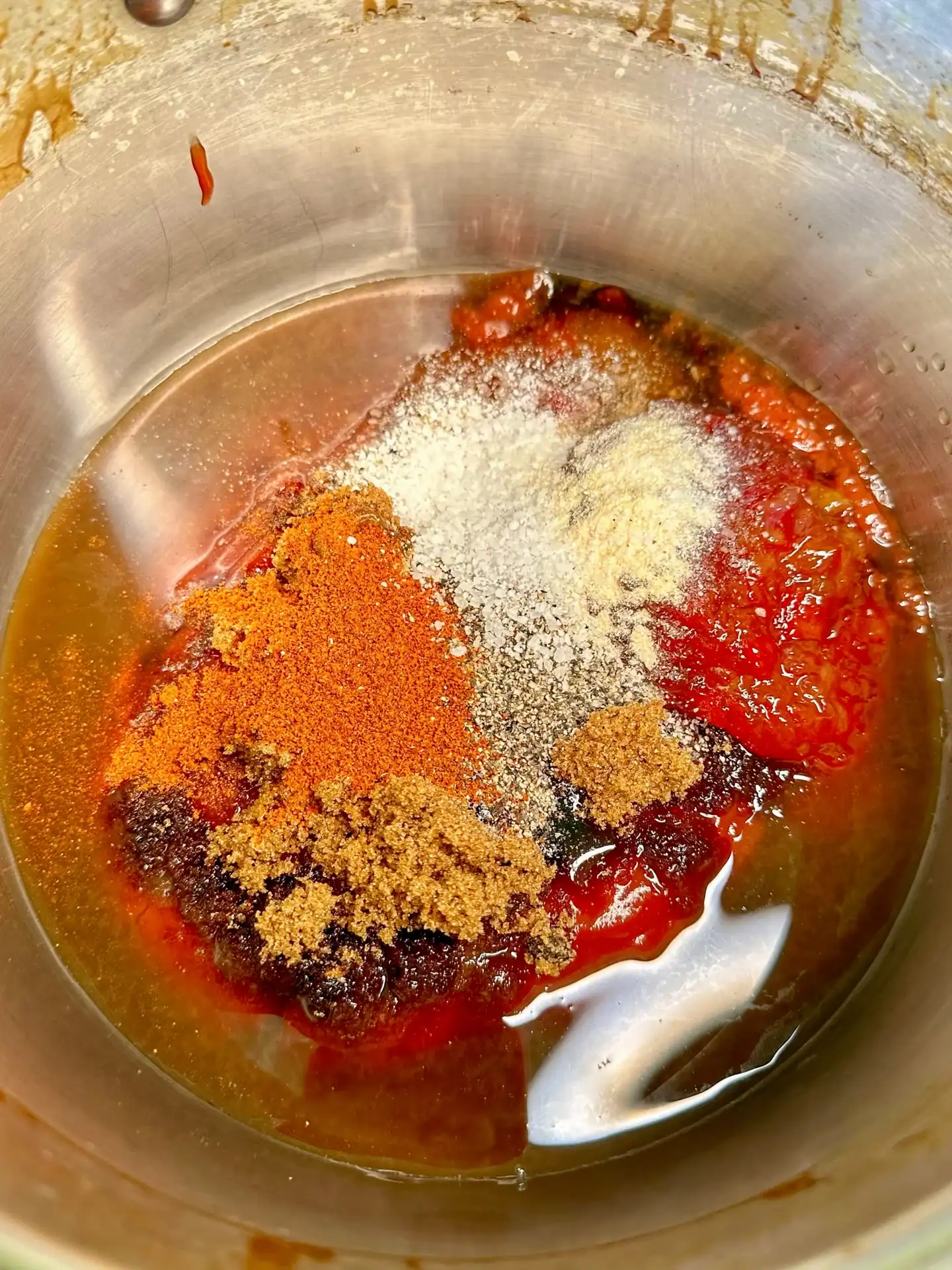 Pineapple molasses BBQ sauce ingredients combined in a saucepan