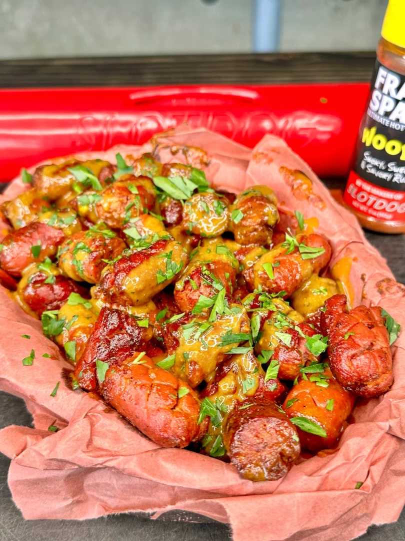 hot dog poor mans burnt ends with carolina gold bbq sauce in a tray