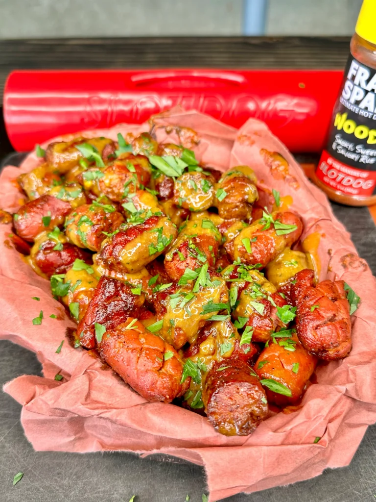 hot dogs from the smoker with a green garnish 