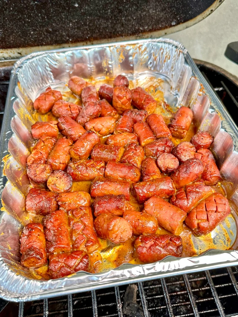 hot dogs in a pan with the carolina sauce on them