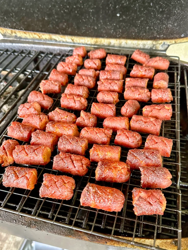 hot dogs with a cross shape on a grill