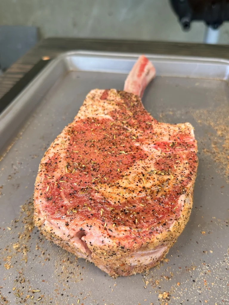 seasoned ribeye on a tray 