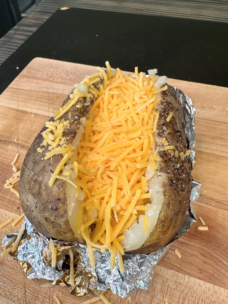 smoked baked potato with cheese in the middle