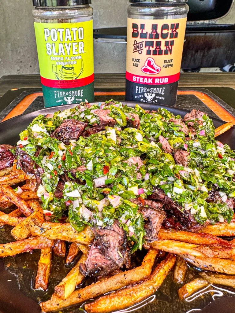 steak fries with chimichurri on a plate