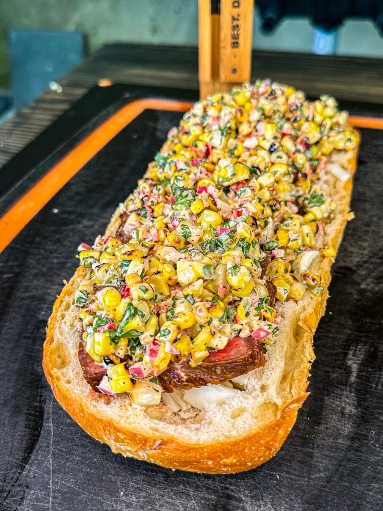 elote in a steak bread boat