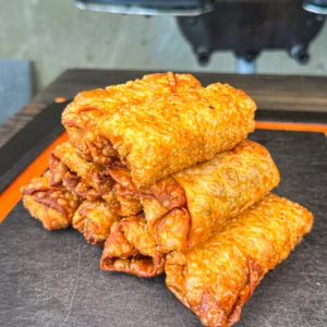 fried egg rolls on a cutting board