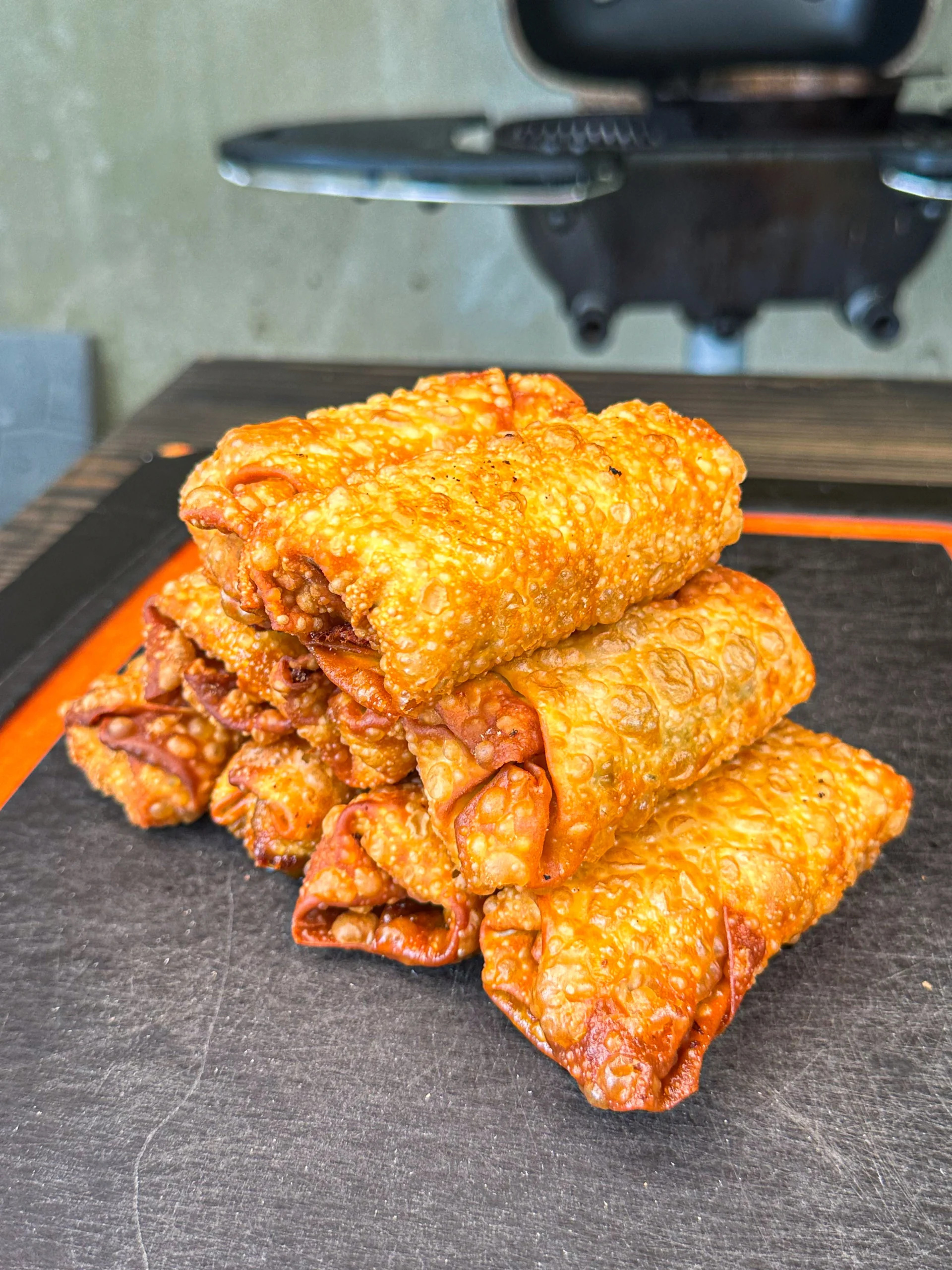 fried egg rolls on a cutting board