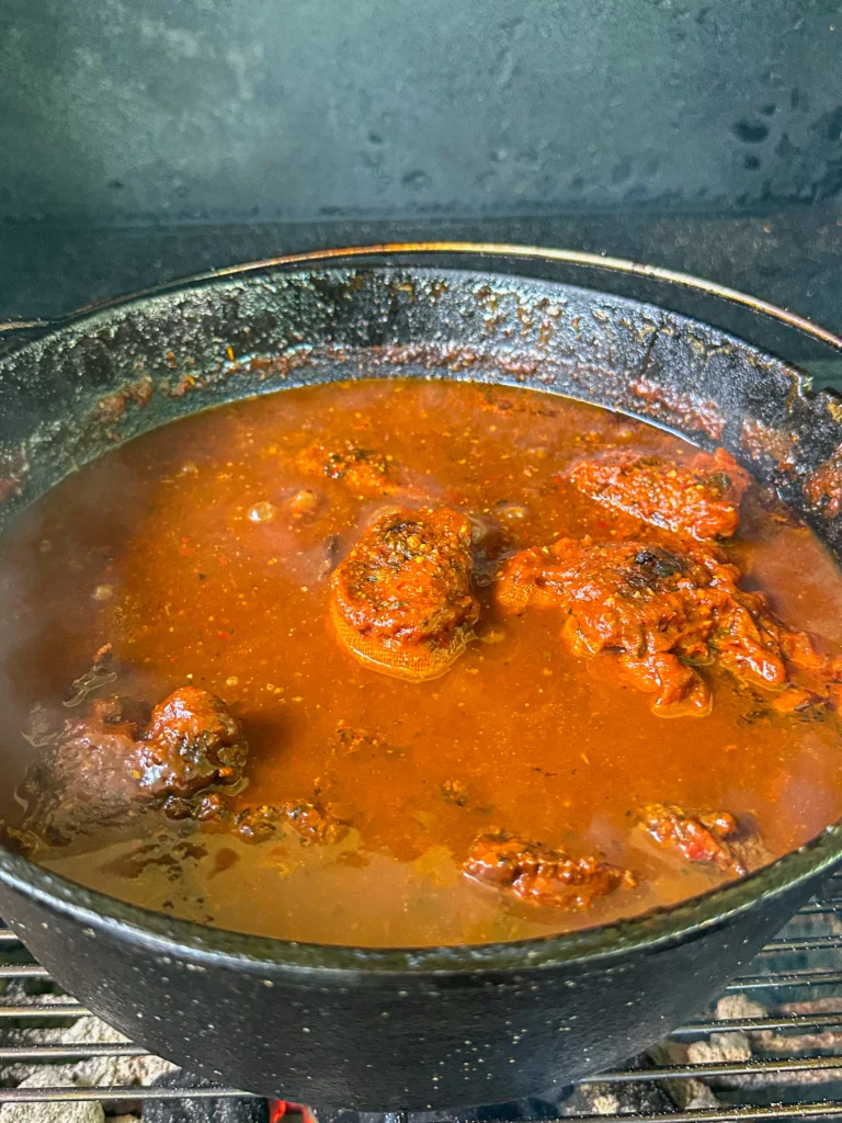 birria being cooked on a hasty bake