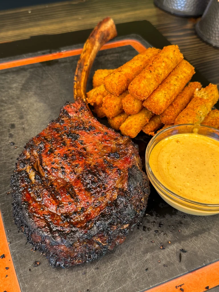 up close of the tomahawk ribeye and fries
